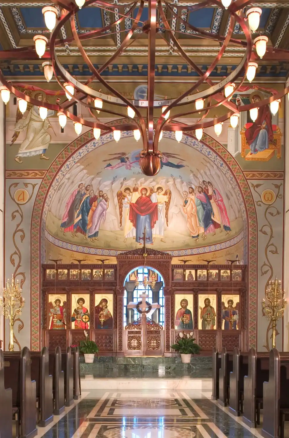 An ornate church interior featuring a large custom chandelier with intricate design at St George Greek Orthodox Church.