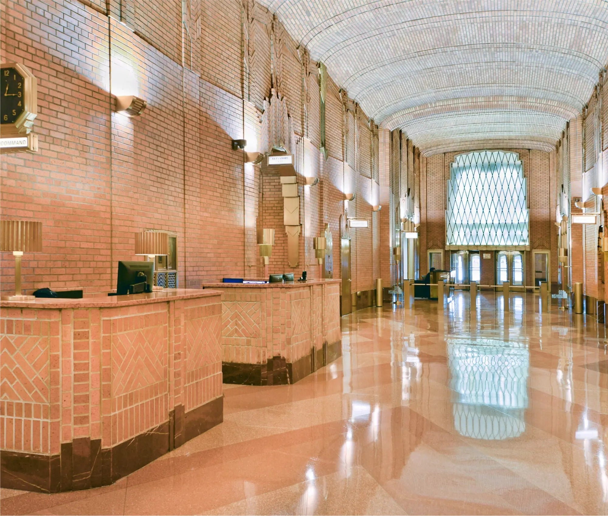 An elegant art deco style hotel lobby with vaulted ceiling showcasing improved lighting at 60 Hudson NYC