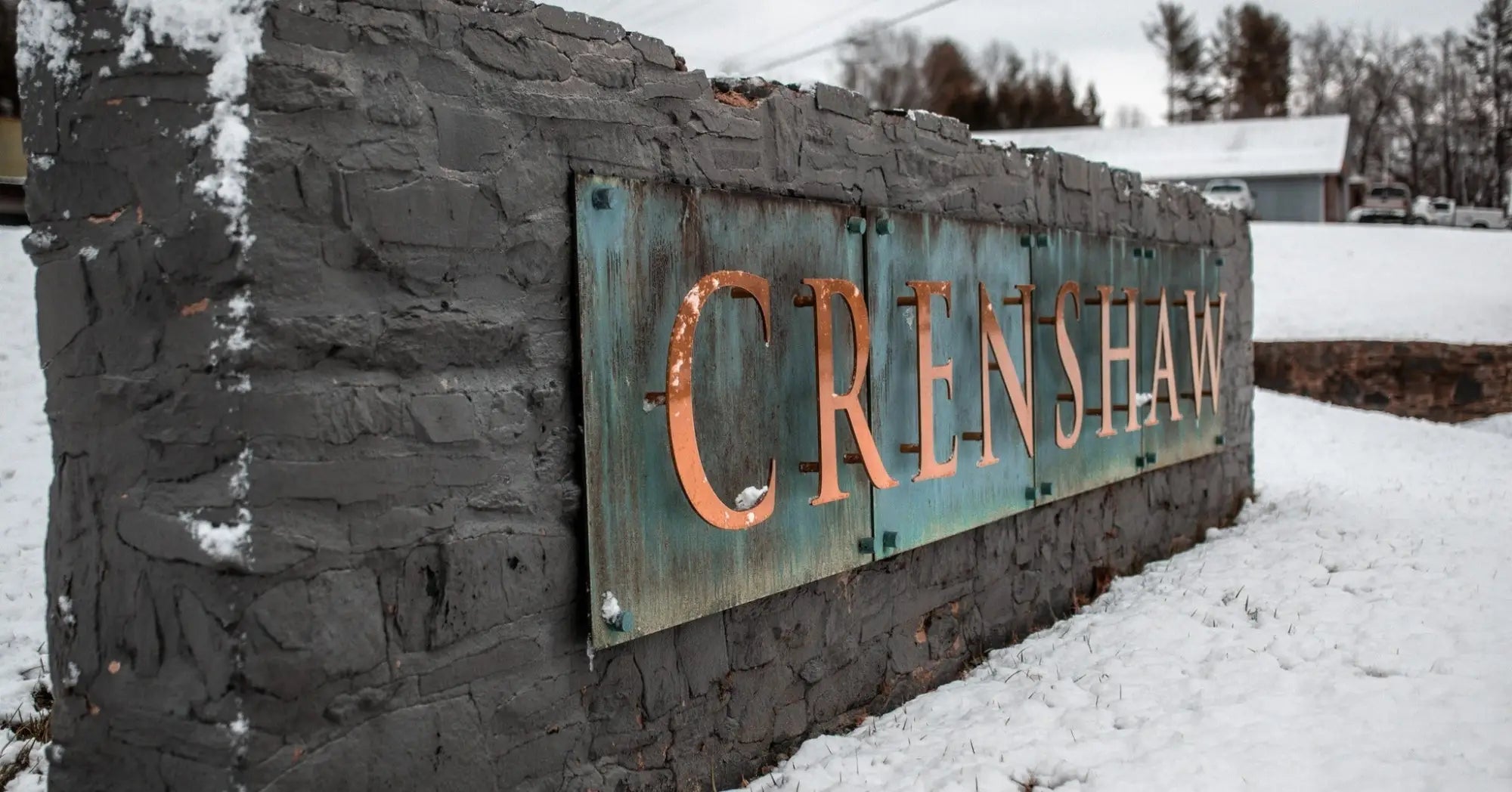 Stone sign with weathered metal lettering marking crenshaw lights prominent d.c. residence entrance