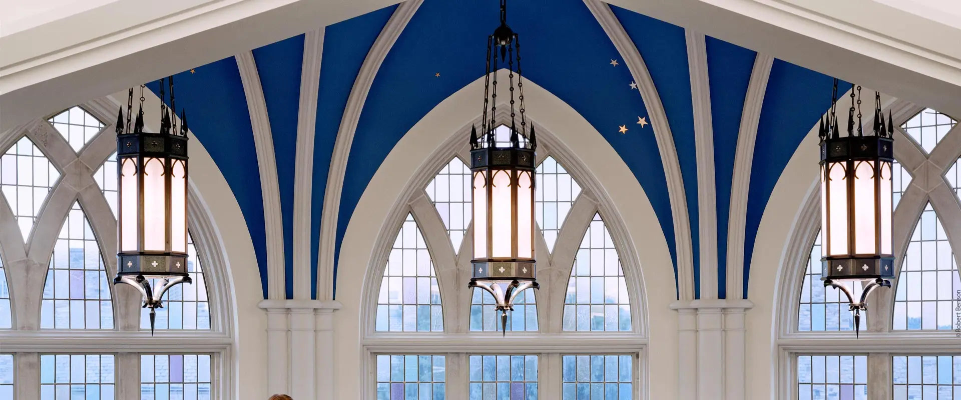 Three gothic-style chandeliers hanging from an arched blue ceiling at paul barrett jr library rhodes college