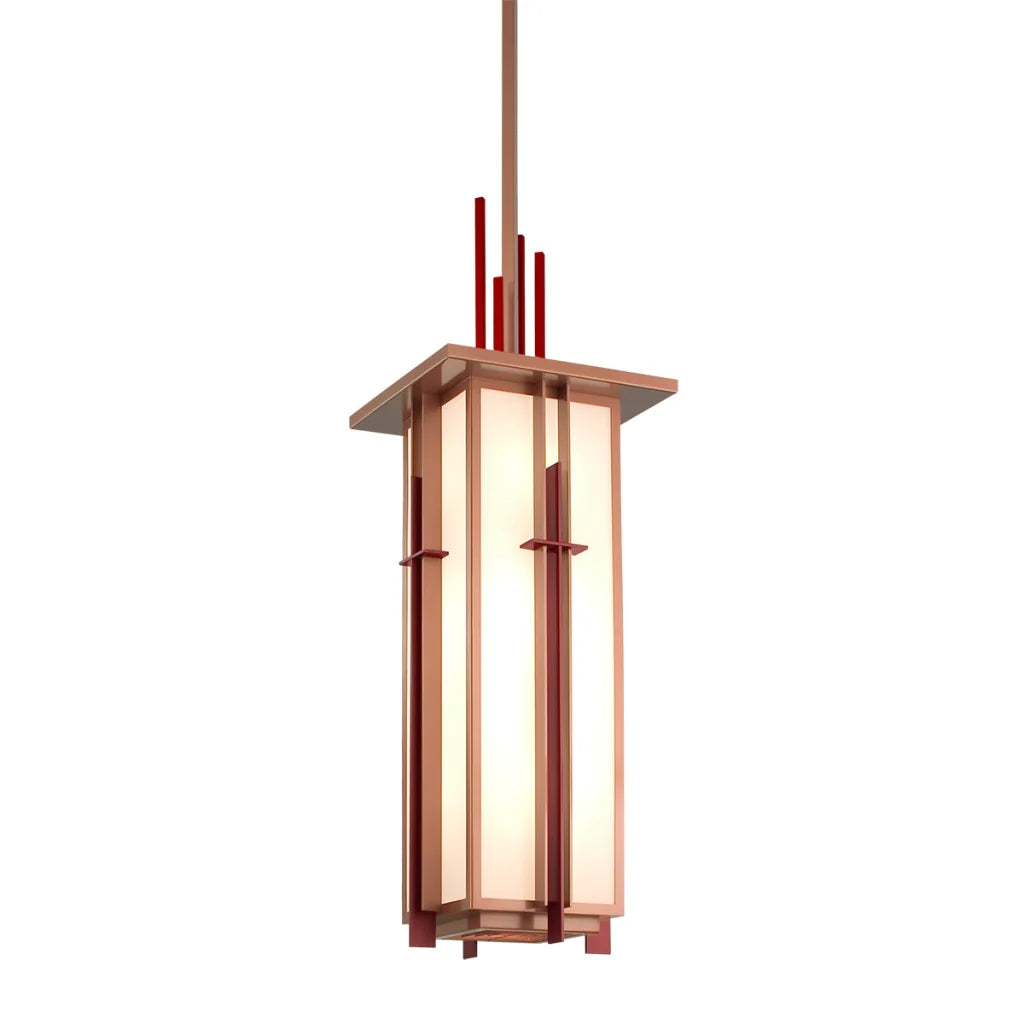 A modern pendant light with a rectangular frame in copper-toned metal, featuring vertical red accents and frosted glass panels that emit warm illumination.