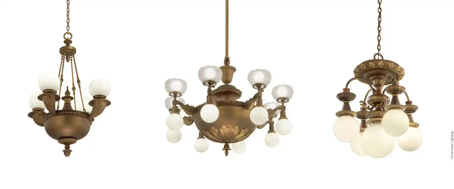 Three antique-style bronze chandeliers with globe lights.