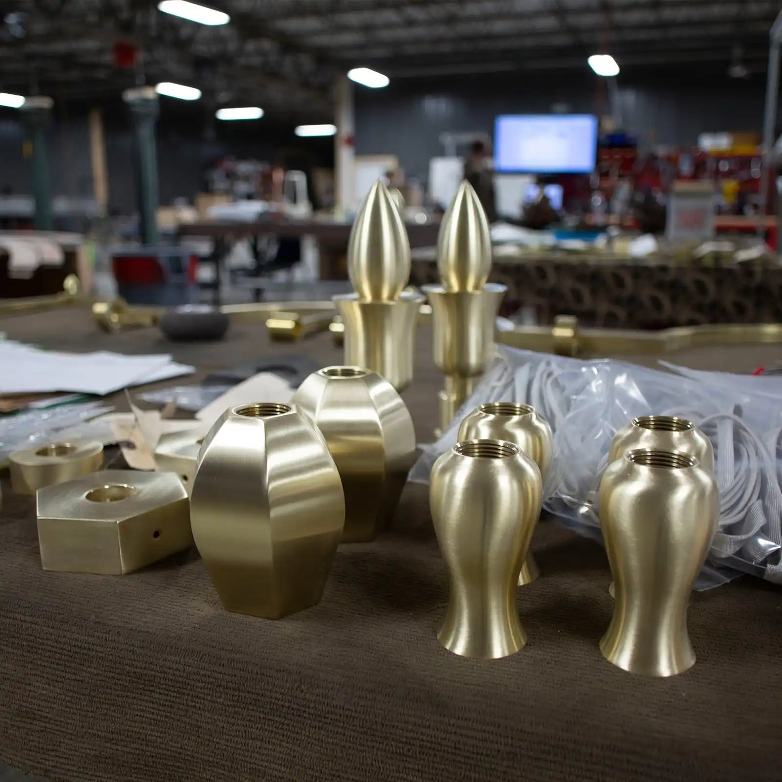 Various brass lamp components with different shapes and finishes