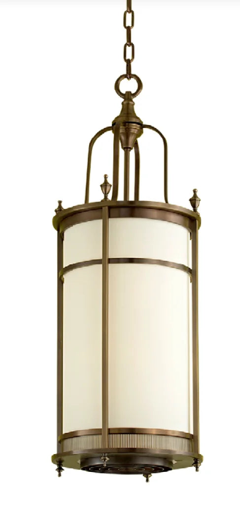 Antique brass lantern with a cylindrical frosted glass shade and decorative metal framing.