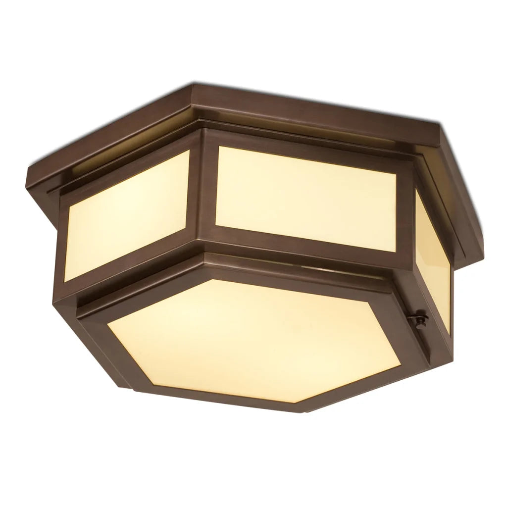 Bronze hexagonal flush mount light fixture with frosted glass panels and a warm glow.