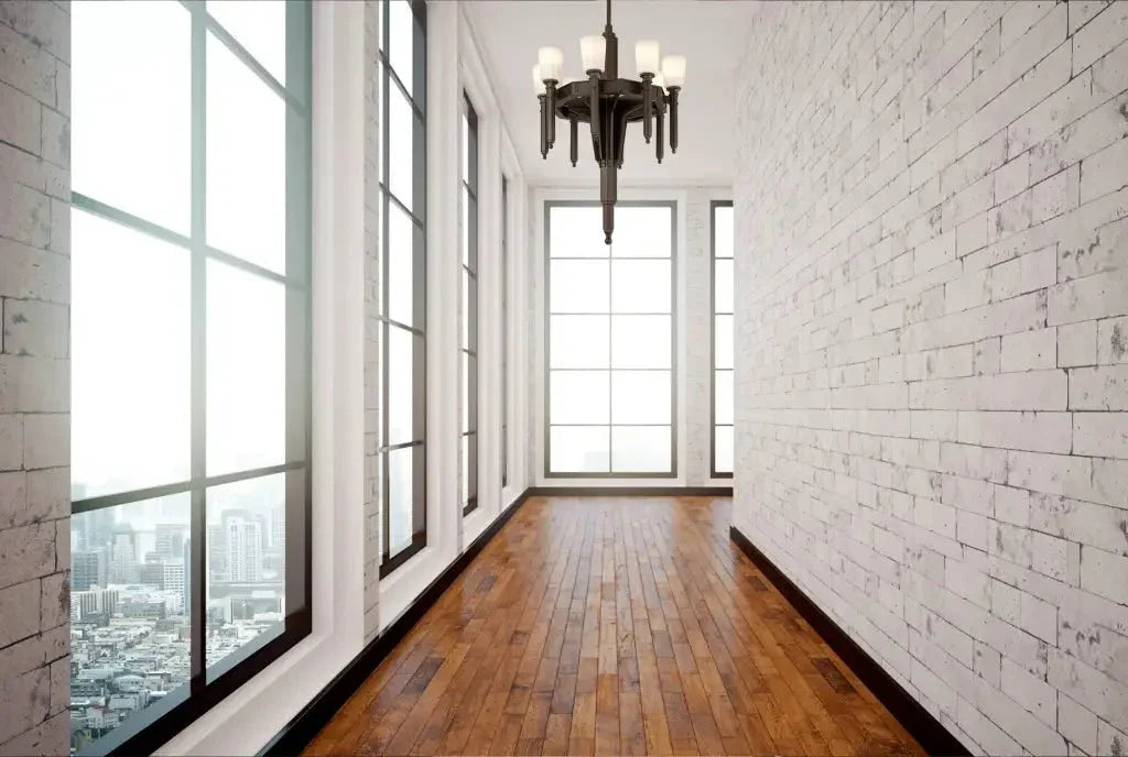 An empty hallway featuring the palladium chandelier with crystal accents, wooden floor, and large windows