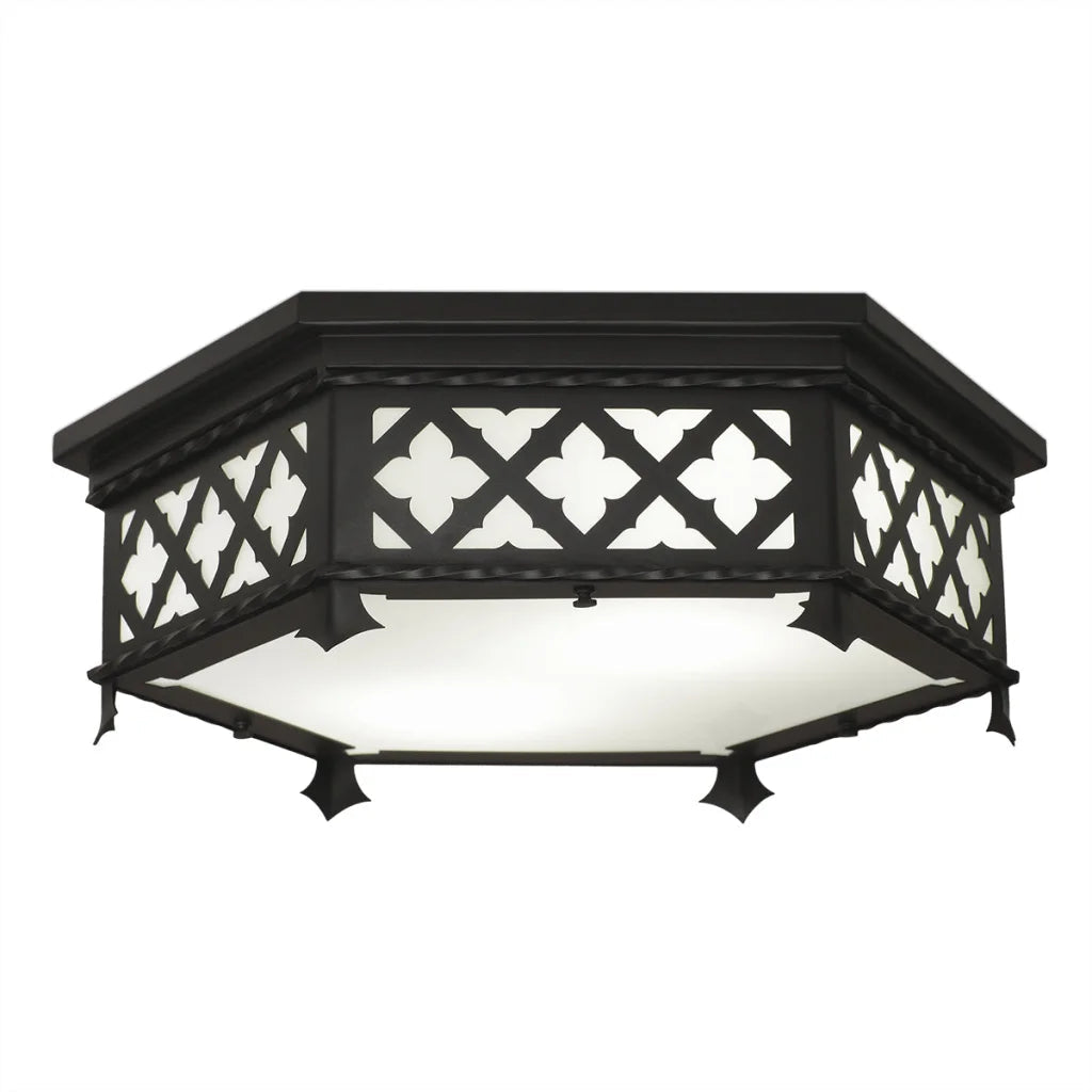 Black wrought iron octagonal ceiling light with decorative quatrefoil lattice pattern and frosted glass panel.