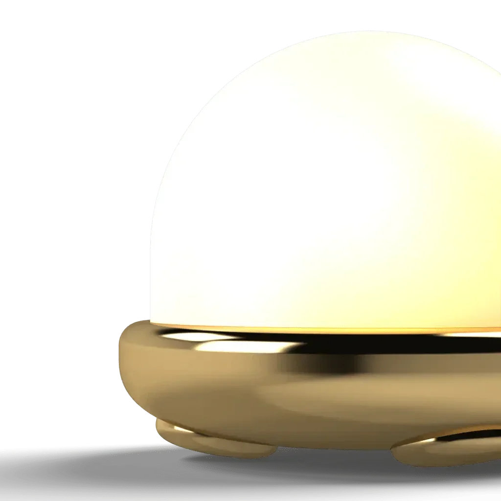 A Trillium table lamp with a glowing dome-shaped light and a golden metal base for stylish indoor lighting