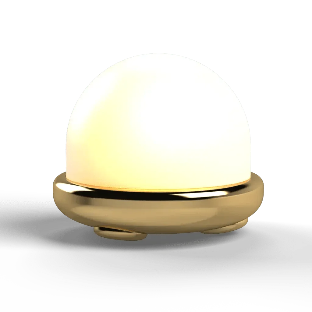 A glowing dome-shaped Trillium table lamp with metallic gold base providing ambient nightlight illumination