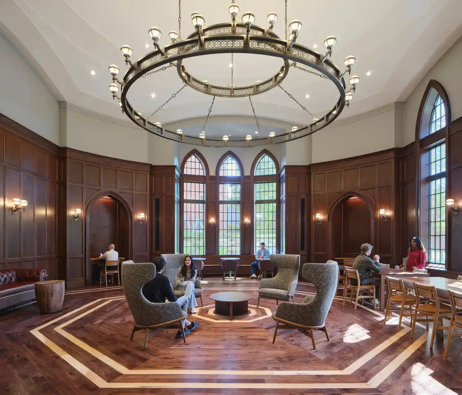 A round, decorative metal chandelier with multiple light fixtures.