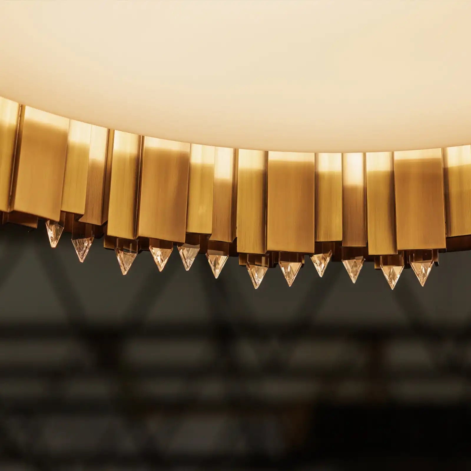 A luxurious gold and crystal chandelier with a circular design.