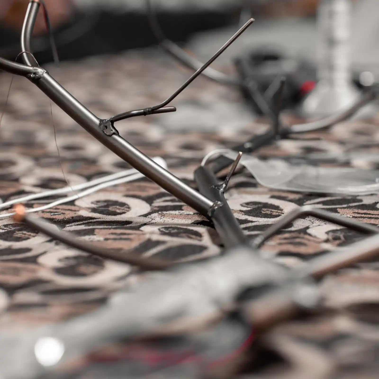 Metallic, tree-branch-like object with slender extensions.