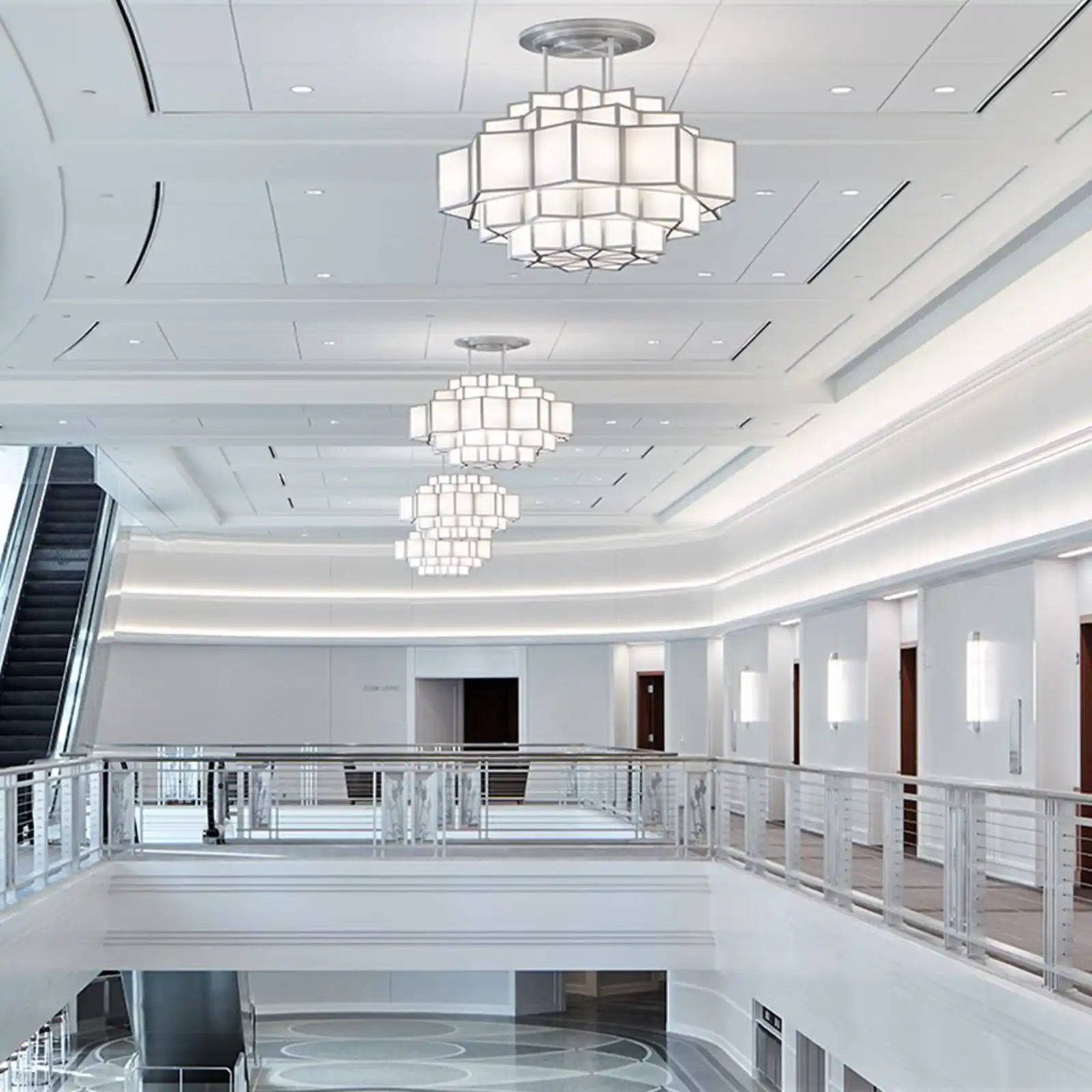 Modern multi-tiered chandelier with square white shades.