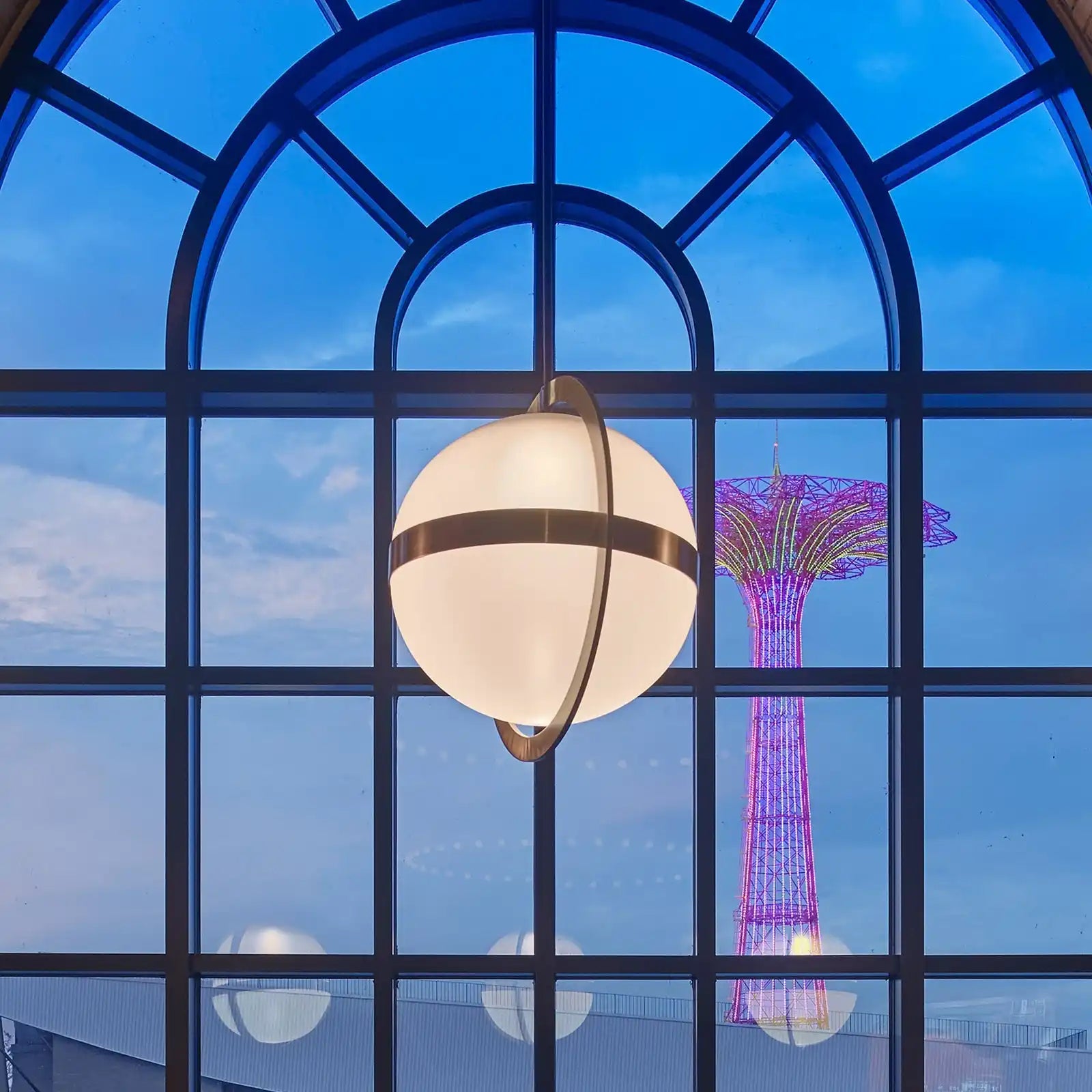 A spherical light fixture with two intersecting metallic bands.