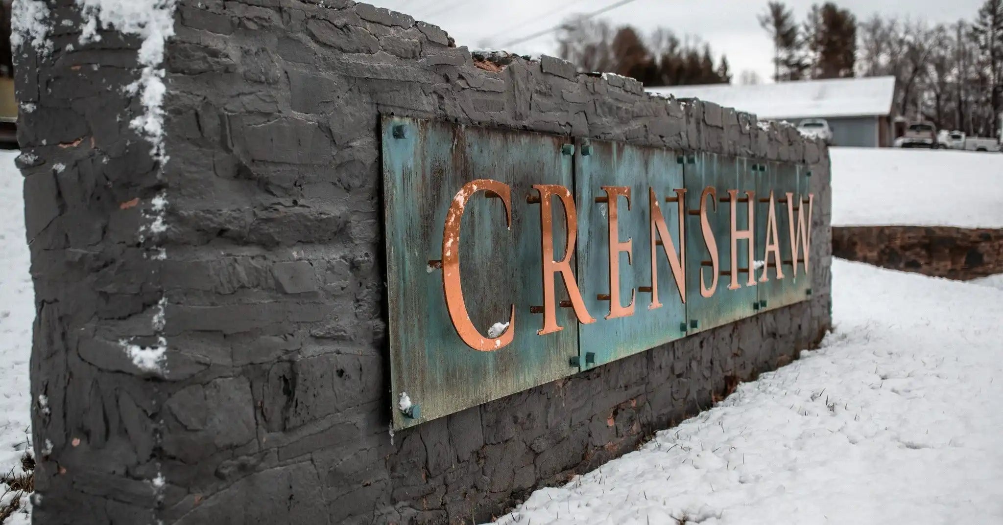 Stone sign with copper letters.