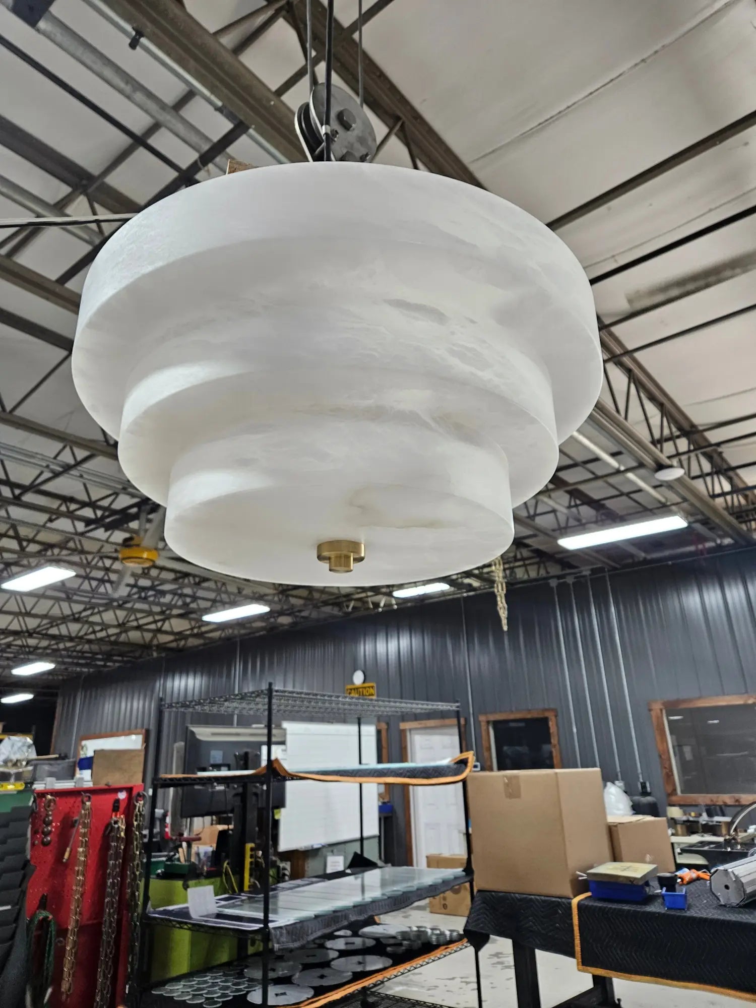 White tiered mushroom-shaped light fixture with brass finial for 15 Central Park West