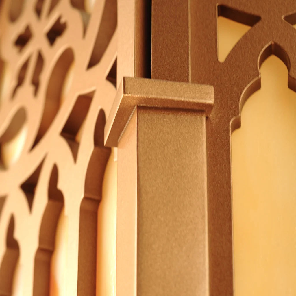 Gold ornate metal door hinge with intricate cutouts and a brushed finish.