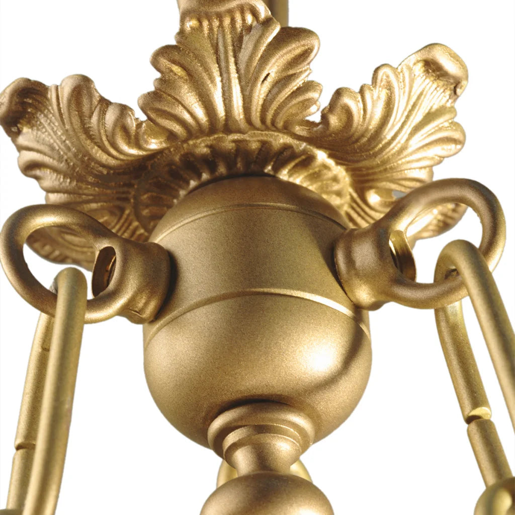 Antique gold chandelier with ornate detailing and leaf accents.