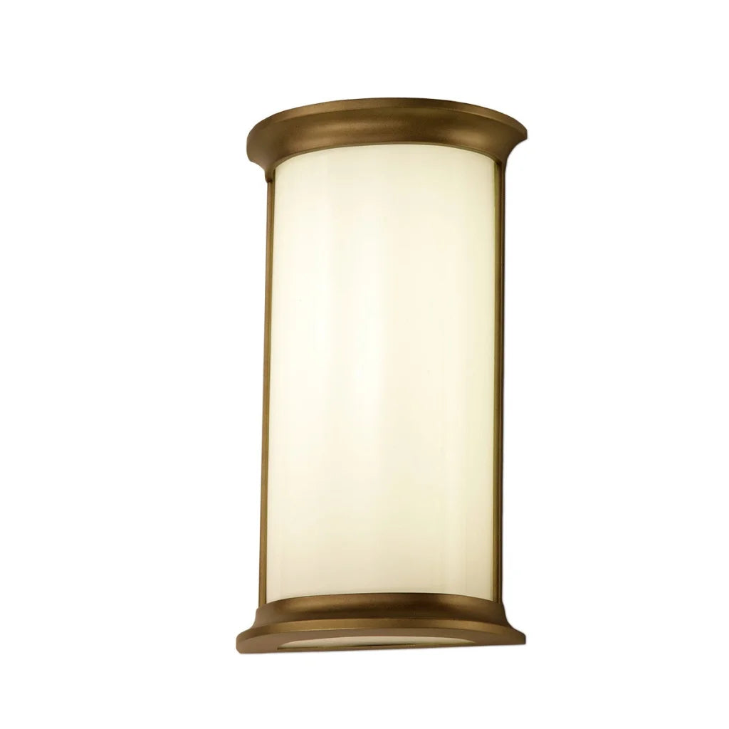 Brass-finished cylindrical wall sconce with a frosted glass diffuser.