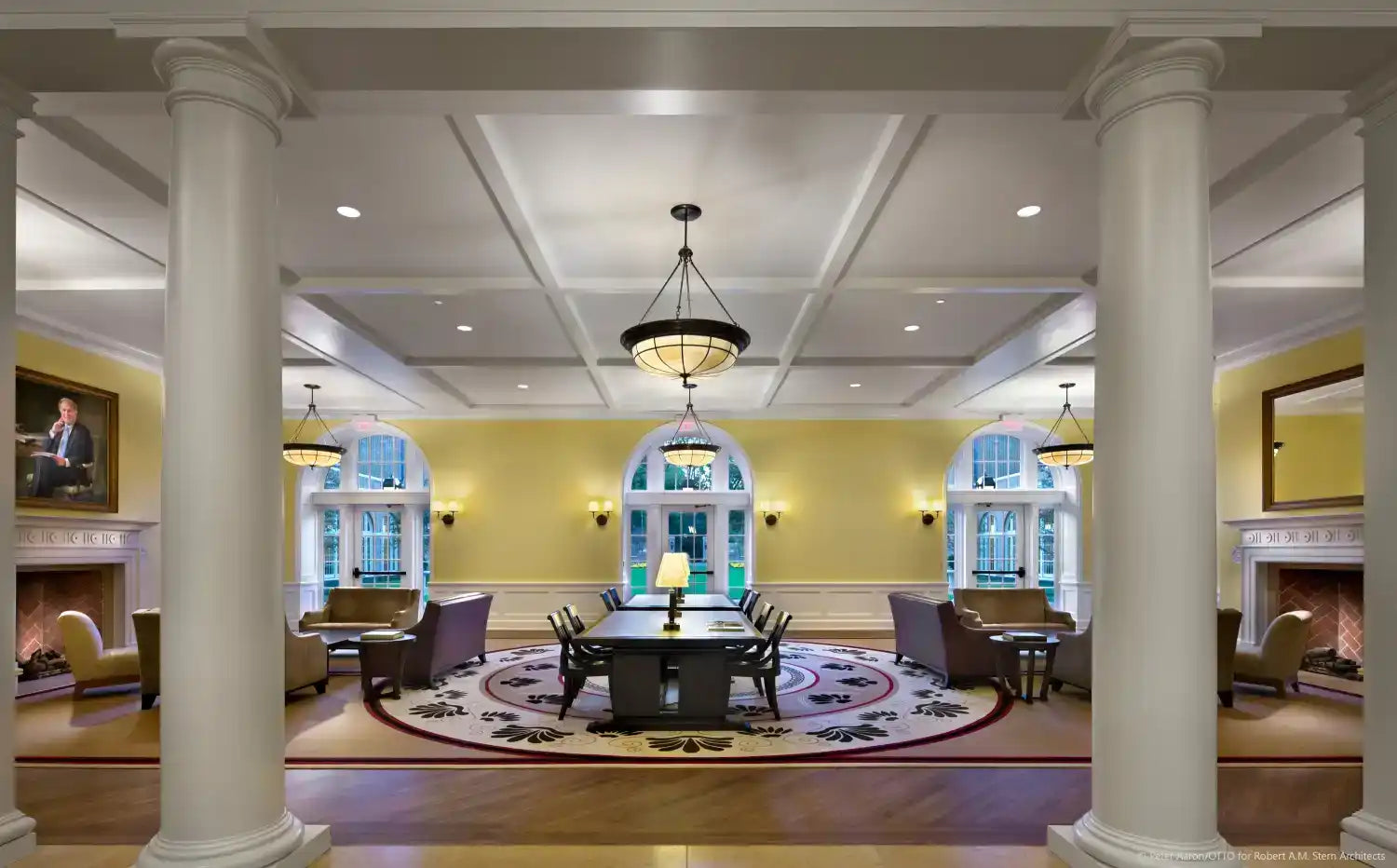 Elegant and spacious common room with multiple seating areas and a large dining table.