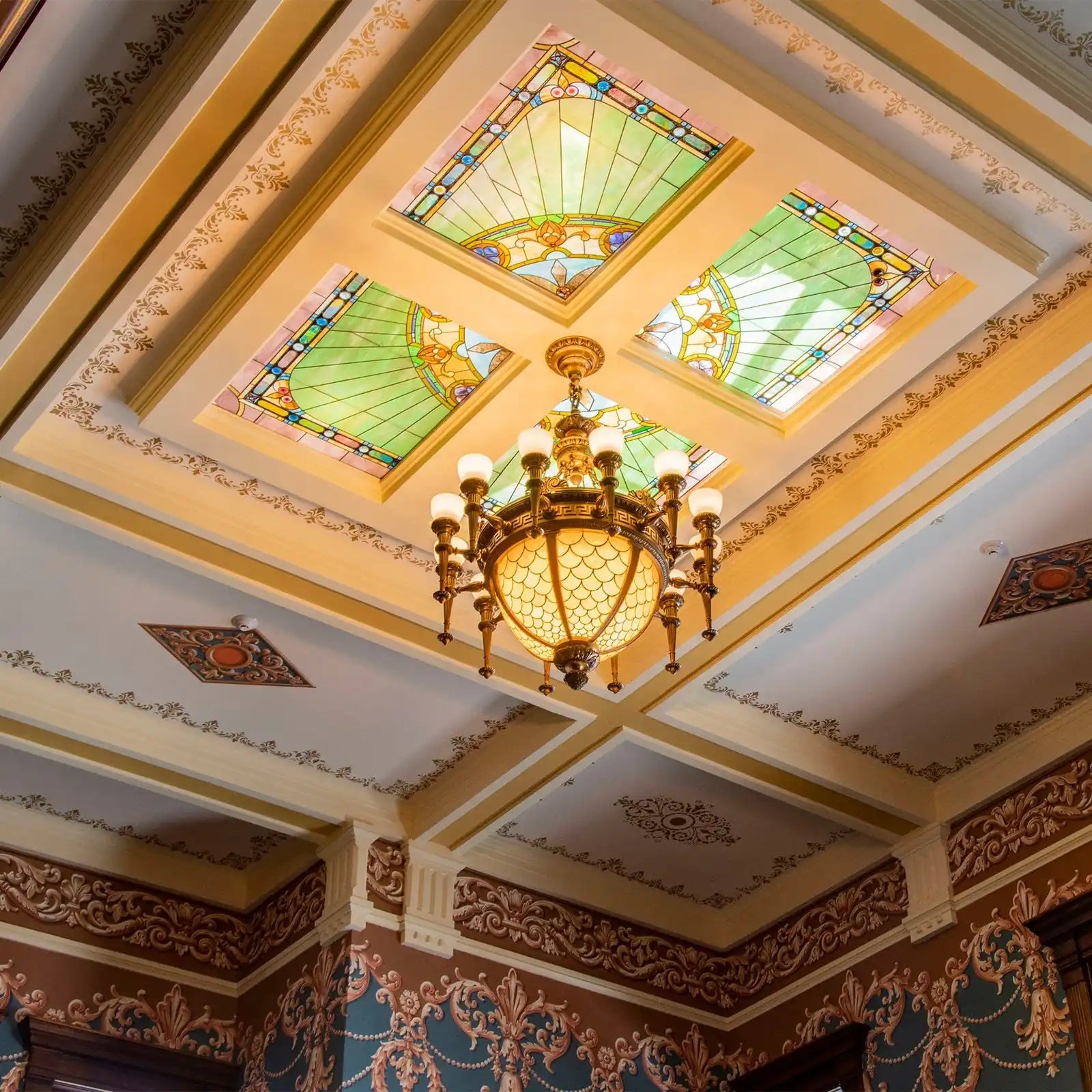 Ornate chandelier with stained glass panels.