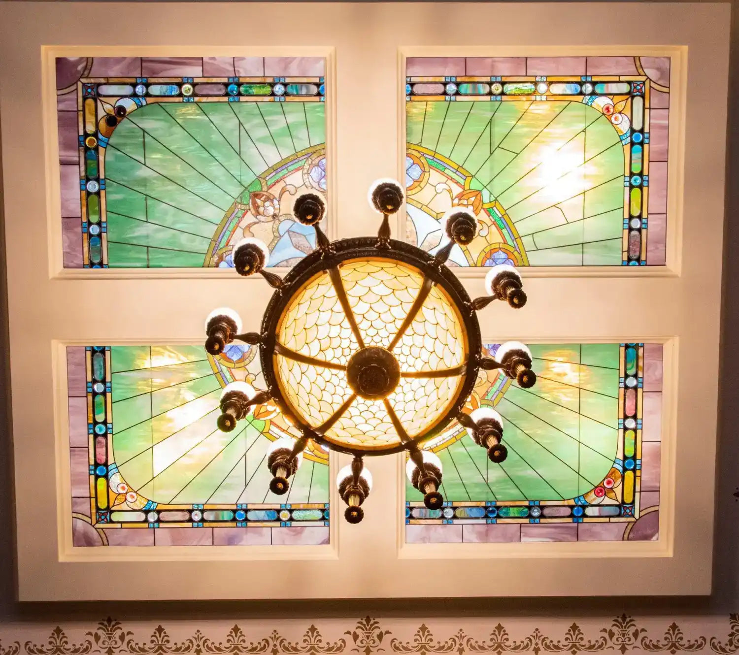 Ornate ceiling chandelier with stained glass panels
