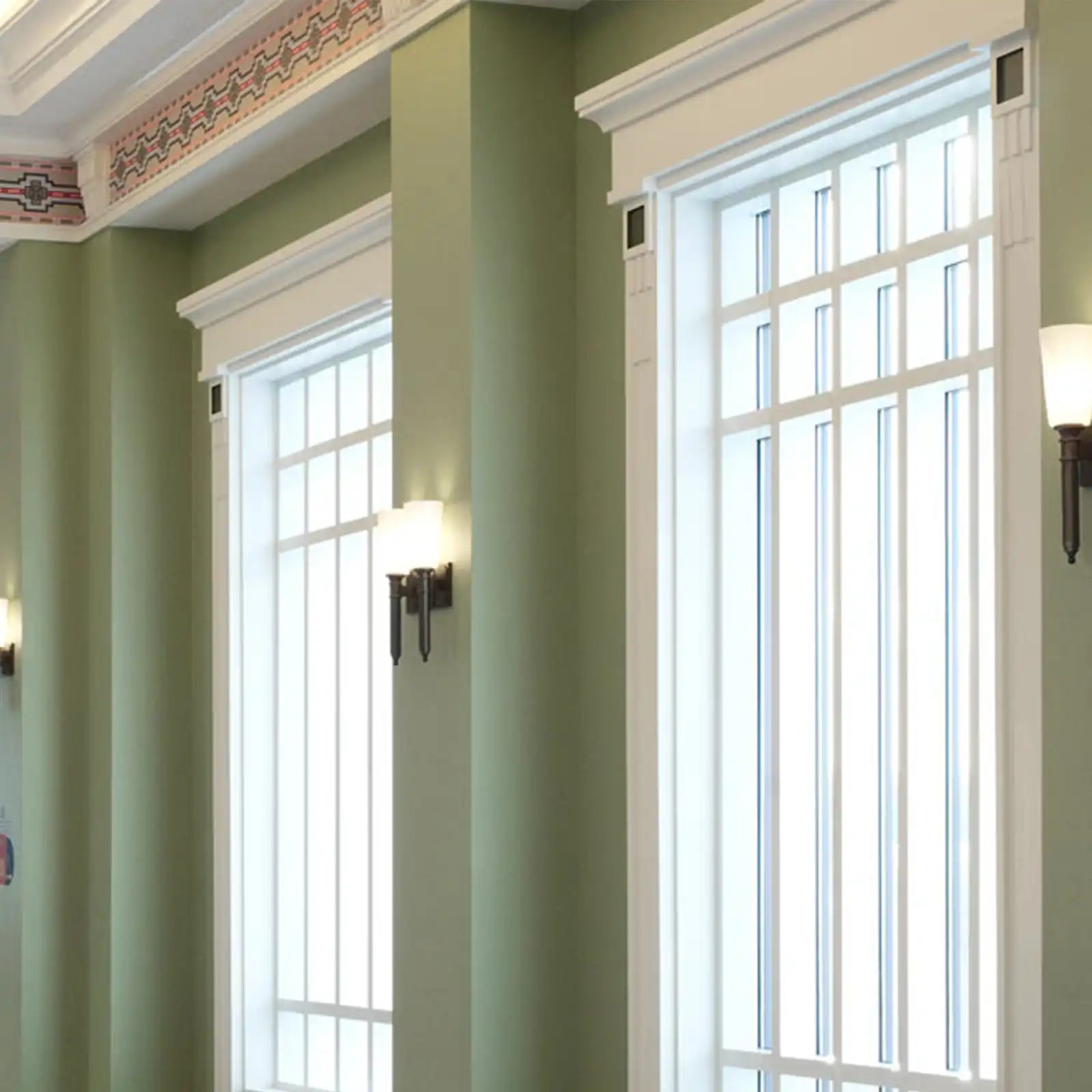 Two tall windows with white frames and vertical bars.
